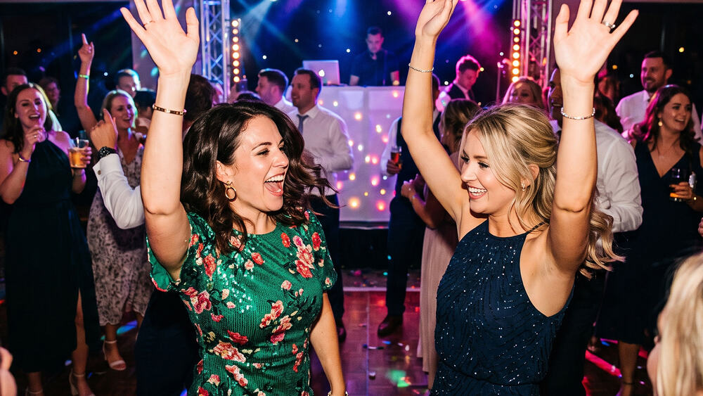 Guests dancing and cheering at a party
